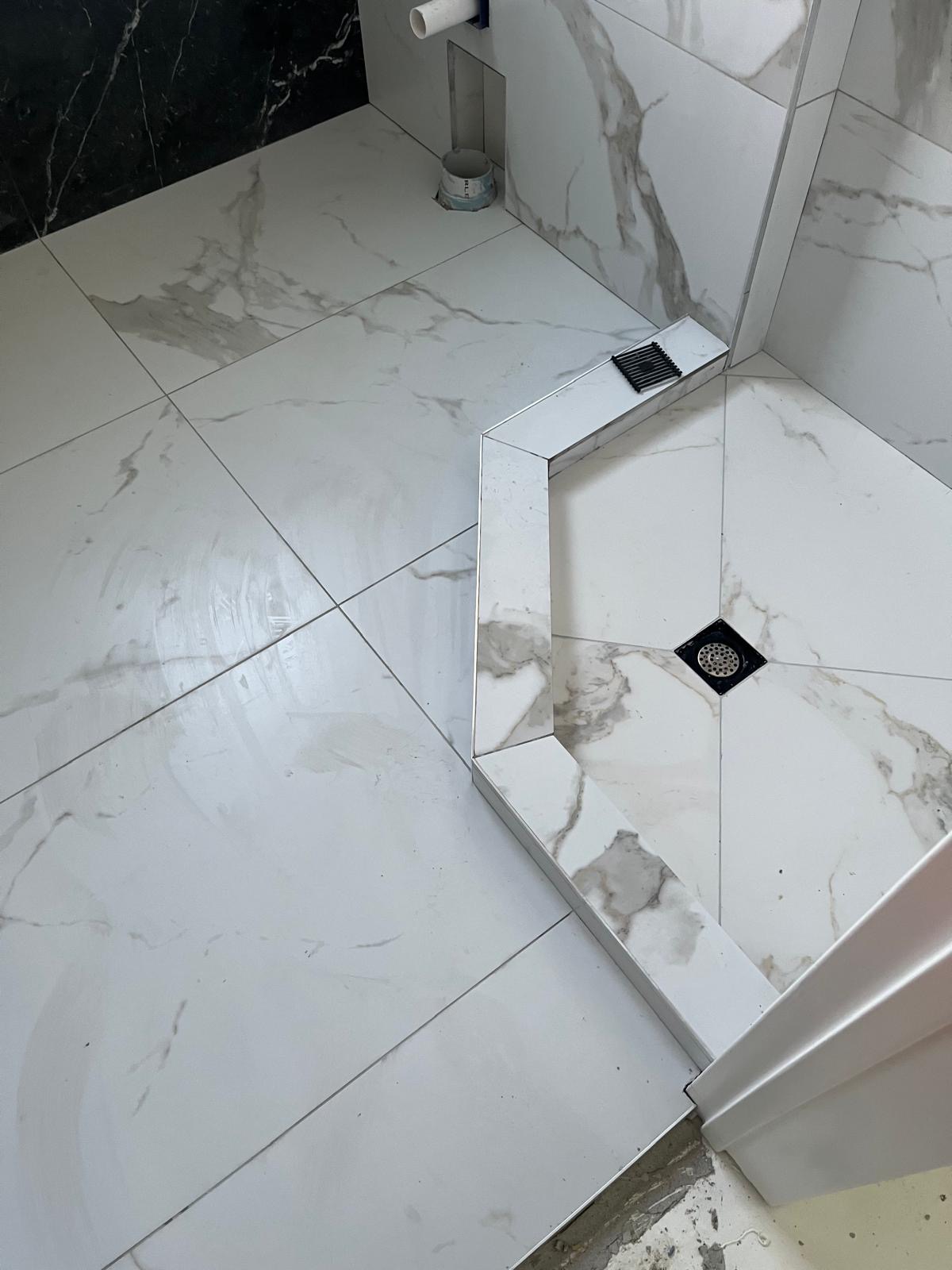 Finished tiled shower step and drain, bathroom renovation